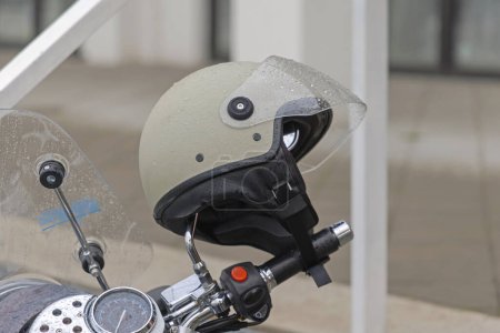 Foto de Moto mojado medio casco cara con visor en el día lluvioso - Imagen libre de derechos