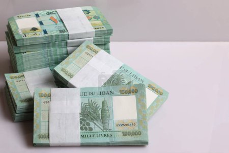 Stacks of Lebanese pounds, 100,000 denomination, symbolizing the downfall of the Lebanese currency.