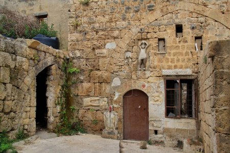 Old building facade in Batroun with ancient stone carvings.