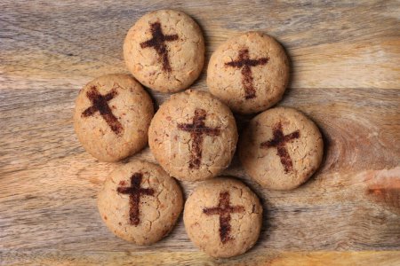 A batch of freshly baked mantecaos biscuits with a crucifix for Easter.