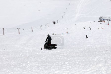 A man riding a skidoo in the snowy slopes of Lebanon.