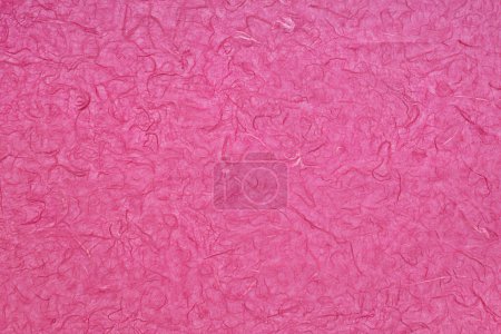 Photo for A flat, handcrafted magenta paper background with a tangled fibrous and somewhat veiny texture - Royalty Free Image
