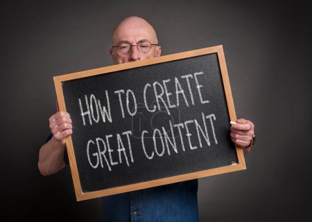 Photo for How to create great content - white chalk text on a balckboard held by a senior man, teacher, mentor or presenter, communication, media and content creation concept - Royalty Free Image