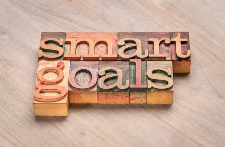 smart goals - Wortabstrakt in Buchdruckbuchstaben vor gemasertem Holzhintergrund, Zielsetzung, Planung, geschäftliche und persönliche Entwicklung