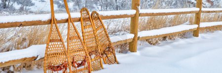 Photo for Classic wooden snowshoes in winter scenery at foothills of Rocky Mountains in northern Colorado, panoramic web banner - Royalty Free Image