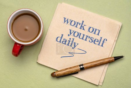 Photo for Work on yourself daily - inspirational advice or reminder on a napkin with coffee, self improvement and personal development concept - Royalty Free Image