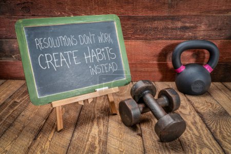 Photo for Resolutions do not work, create habits instead -  inspirational advice or reminder, chalk writing on a slate blackboard with dumbbells and kettlebell, fitness, New Year, setting goals and personal development concept - Royalty Free Image
