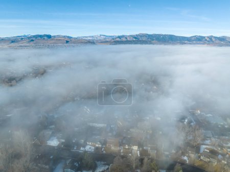 Photo for Foggy winter morning over Rocky Mountains and Fort Collins, Colorado, aerial view - Royalty Free Image