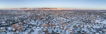 Téléchargez les photos : Winter sunrise over residential area of Fort Collins and Rocky Mountains foothills in northern Colorado, aerial panorama view - en image libre de droit