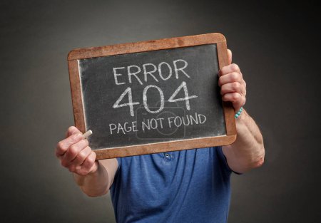 Foto de Page not found 404 error - white chalk text on a slate blackboard held by a person, HTTP status code - Imagen libre de derechos