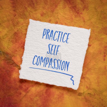 Foto de Practice self-compassion inspirational handwriting on an art paper, mindset and personal development concept - Imagen libre de derechos