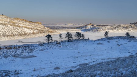 Photo for Winter scenery in foothills of Rocky Mountains in northern Colorado with frozen Horsetooth Reservoir - Royalty Free Image
