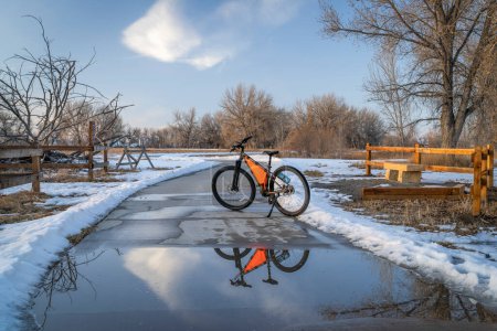 Photo for Mountain bike on Poudre River Trail near Greeley in Colorado, winter scenery with puddle reflection - Royalty Free Image