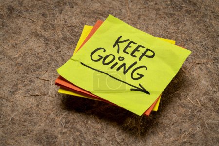 Foto de Keep going - motivation or determination concept - handwriting on a sticky note - Imagen libre de derechos