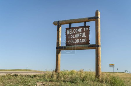 Photo for Welcome to colorful Colorado roadside wooden sign at a border with Nebraska in eastern Colorado - Royalty Free Image