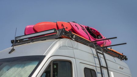 Photo for Whitewater kayaks on roof racks of a camper van - Royalty Free Image
