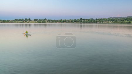 Photo for Evening canoe paddling on one of numerous reservoirs along Front Range in Colorado - Royalty Free Image
