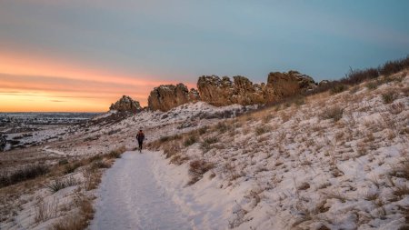 Photo for Winter sunrise over a trail at Colorado foothills with a distant runner - Devils Backbone rock formation near Loveland - Royalty Free Image