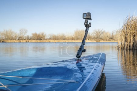 Photo for Fort Collins, CO, USA - April 6, 2023: GoPro 10 action camera mounted on a deck of stand up paddleboard (2023 Waterline model by Starboard) on a lake shore. - Royalty Free Image