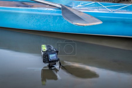 Photo for Fort Collins, CO, USA - April 12, 2023: Waterproof action camera, Sony RX0 II, in a cage with a bubble level mounted on a mini tripod for shooting stand up paddling on a lake. - Royalty Free Image
