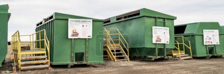 Photo for Fort Collins, CO, USA - April 13, 2023: Recycling center - a row of green steel containers with instruction signs at Larimer County landfill. - Royalty Free Image