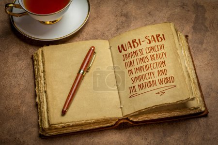 Photo for Wabi-sabi - Japanese concept that finds beauty in imperfection, simplicity, and the natural world, handwriting in a retro journal with a cup of tea - Royalty Free Image