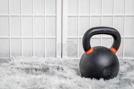 Téléchargez les photos : Kettlebell en fer lourd dans une salle de gym à domicile, concept de fitness - en image libre de droit