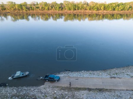 Photo for Launching a fishing boat at a ramp - sunrise aerial view of Missouri River at Dalton Bottom - Royalty Free Image