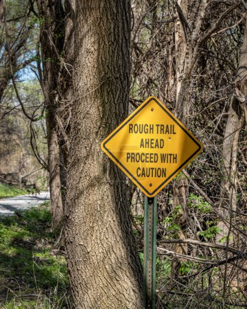 Photo for Rough trail ahead, proceed with caution - warning sign on Steamboat Trace Trail converted from old railroad near Peru, Nebraska - Royalty Free Image