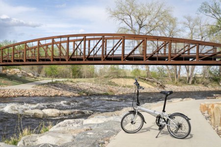 Photo for Lightweight folding bike at whitewater park on the Poudre River in downtown of Fort Collins, Colorado, spring scenery - Royalty Free Image