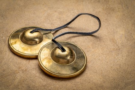 Photo for Tingsha cymbals used in the Tibetan religion in prayers, rituals, meditation, and healing - Royalty Free Image