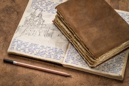 Photo for Detail from a 1970s vintage travel journal with handwriting and pencil sketches (property release attached) and a retro leather-bound diary - Royalty Free Image