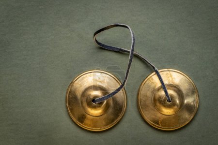 Photo for Tingsha cymbals used in the Tibetan religion in prayers, rituals, meditation, and healing - Royalty Free Image