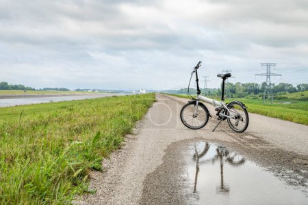 Photo for Folding bike on a levee trail along Chain of Rocks Canal near Granite City in Illinois - Royalty Free Image