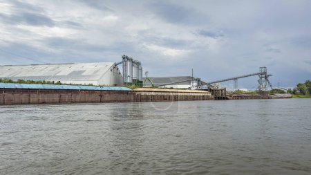 Photo for Barges on the Missouri River at an industrial terminal - Royalty Free Image