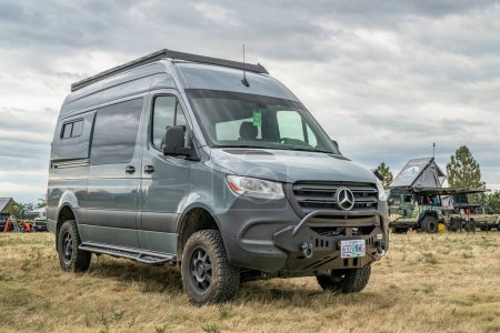 Photo for Loveland, CO, USA - August 25, 2023: 4x4 camper van on Mercedes Sprinter chassis with a custom front bumper and winch at a busy campground. - Royalty Free Image