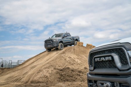 Photo for Loveland, CO, USA - August 26, 2023: RAM Rebel trucks on a muddy training off-road trail course. - Royalty Free Image
