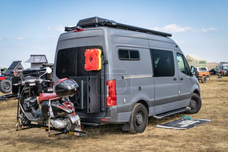 Photo for Loveland, CO, USA - August 26, 2023: 4x4 camper van on Mercedes Sprinter chassis with Vespa scooter on a hitch rack in a busy campground. - Royalty Free Image