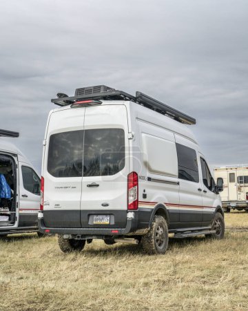 Téléchargez les photos : Loveland, CO, États-Unis - 26 août 2023 : Storyteller Overland Mode LT, camping-car 4x4 basé sur le châssis Ford Transit dans un terrain de camping animé. - en image libre de droit