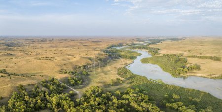 Photo for Aerial panorama of the Dismal River meandering through Nebraska Sandhills at Nebraska National Forest, late summer scenery at sunset - Royalty Free Image