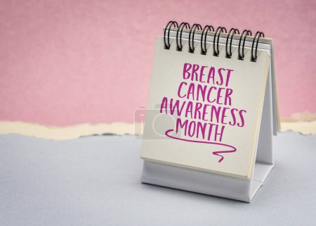 Photo for Breast Cancer Awareness Month - reminder note in desktop calendar, health and education concept - Royalty Free Image