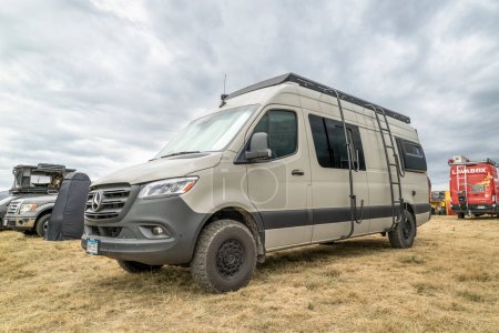 Photo for Loveland, CO, USA - August 25, 2023: Mercedes Sprinter camper van with a roof ladder and surfboard or paddleboard racks. - Royalty Free Image
