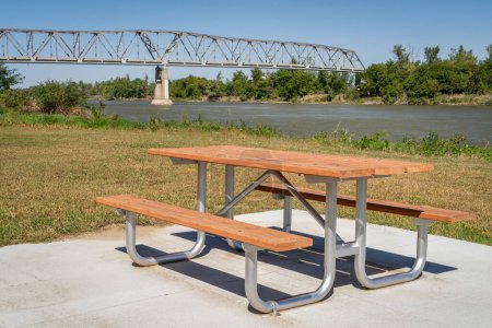 Photo for Picnic table and  truss bridge over the Missouri River at Brownville, Nebraska, in fall scenery - Royalty Free Image