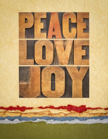 Photo for Peace, love and joy typography  abstract in letterpress wood type on art paper - Merry Christmas concept - Royalty Free Image