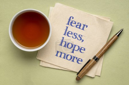 Photo for Fear less, hope more - words of wisdom on a napkin with tea, stress and personal development concept - Royalty Free Image