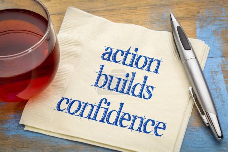 Photo for Action builds confidence - inspirational note on anpkin with tea, personal development concept - Royalty Free Image