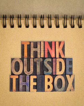 Photo for Think outside the box concept - motivational phrase in vintage letterpress wood type in a spiral notebook - Royalty Free Image