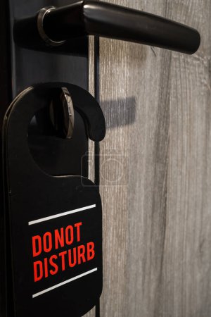 Photo for Do not disturb sign hanging on door key - Royalty Free Image