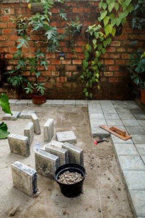Photo for Concrete block floor construction work for courtyard patio as house exterior - Royalty Free Image