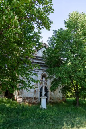 An old ruined church from the XVII century in a forest.